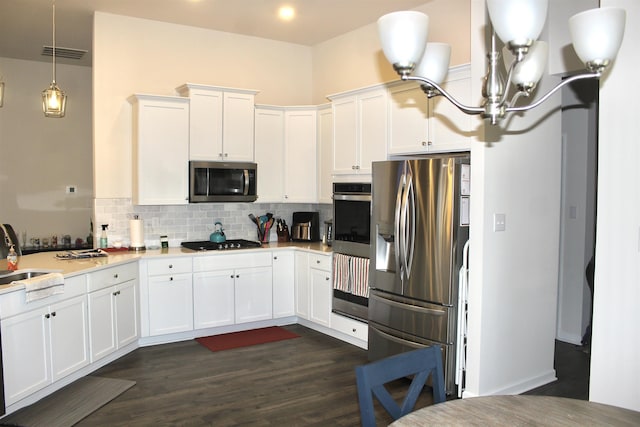 kitchen with visible vents, light countertops, appliances with stainless steel finishes, white cabinetry, and tasteful backsplash