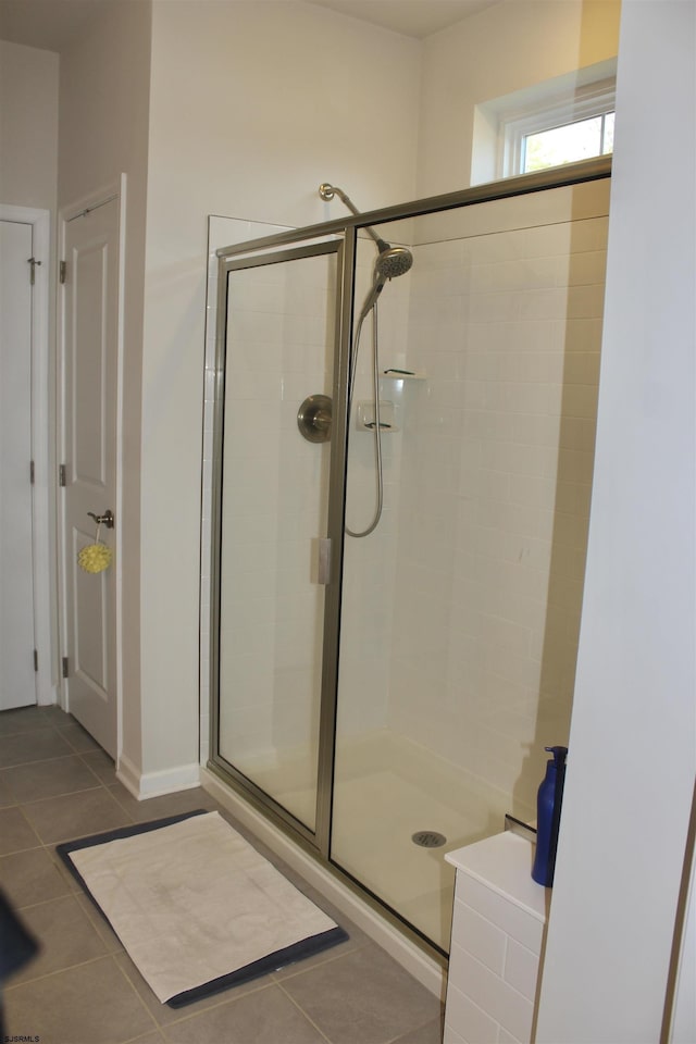 bathroom featuring a shower stall and tile patterned flooring