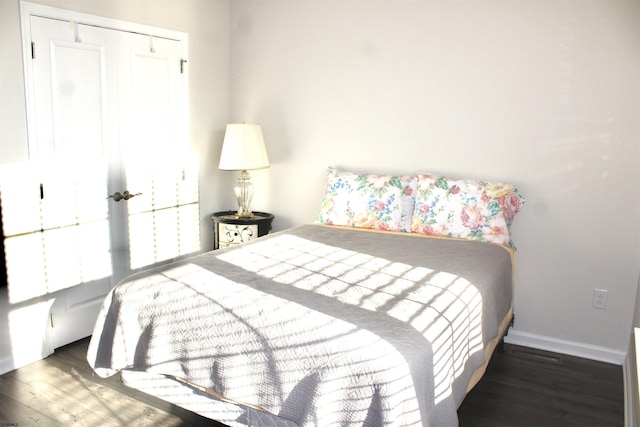 bedroom featuring baseboards and wood finished floors