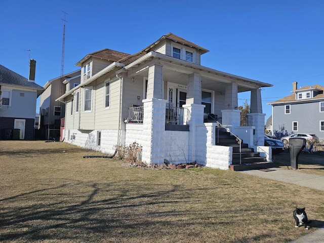 view of front of property with covered porch and a front yard