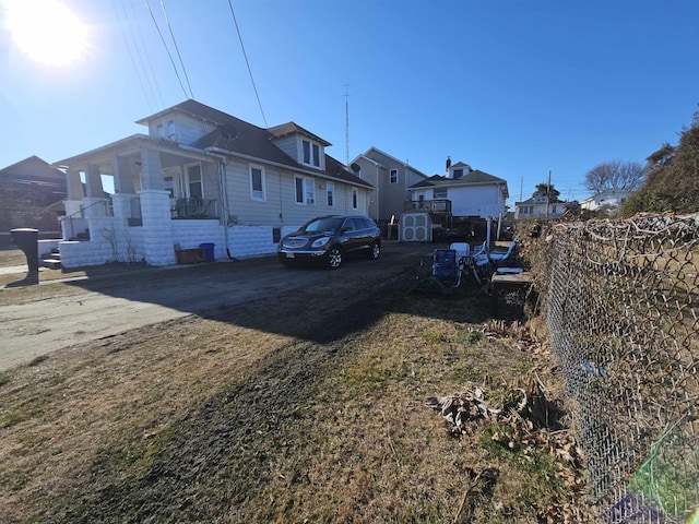 view of side of property with central air condition unit and fence