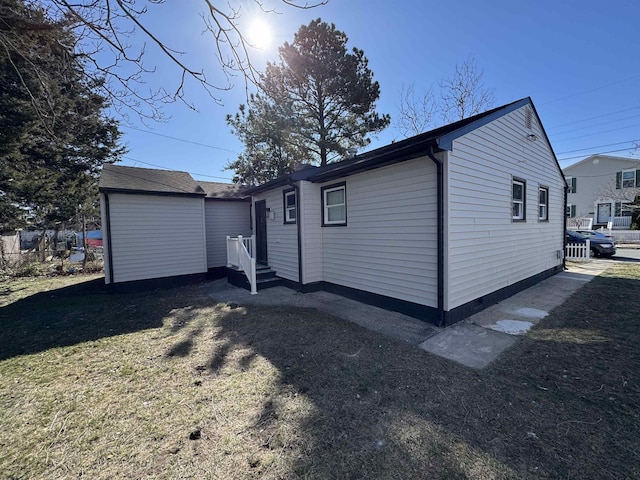 view of side of home featuring a yard