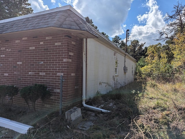 view of property exterior featuring brick siding