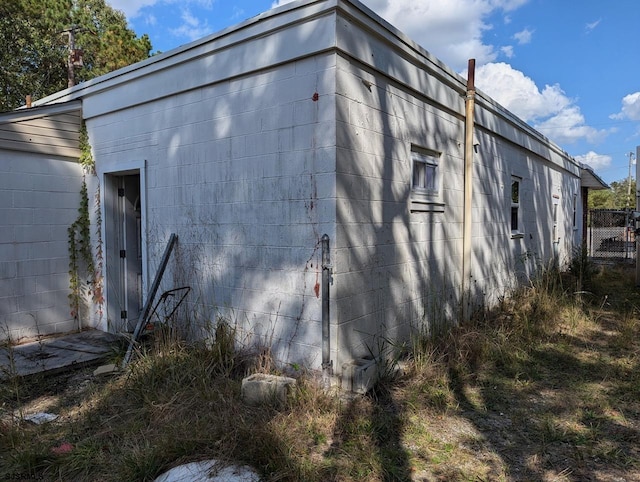 view of side of property with concrete block siding