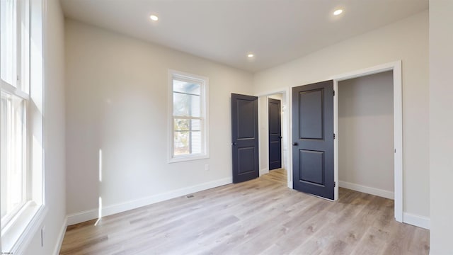 unfurnished bedroom featuring recessed lighting, baseboards, and light wood-style floors