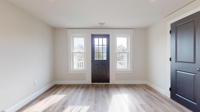 foyer with visible vents, baseboards, and light wood-style floors