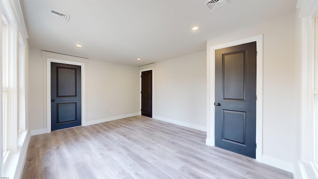 spare room featuring visible vents, recessed lighting, baseboards, and light wood-style floors