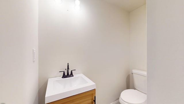 bathroom with toilet and vanity