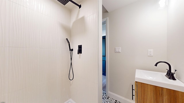 full bathroom featuring vanity and a tile shower