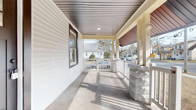 view of patio featuring a residential view and a porch