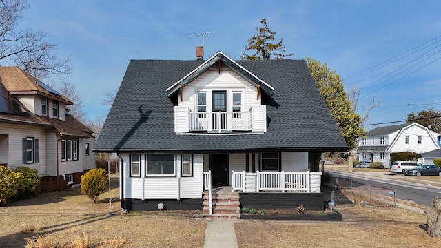 bungalow-style house featuring a porch, a chimney, a balcony, and a shingled roof