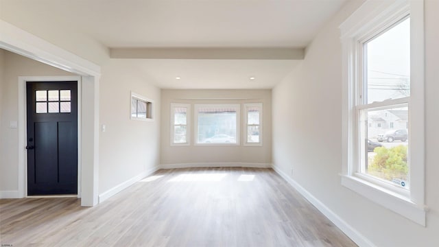 entryway with baseboards and light wood-style floors