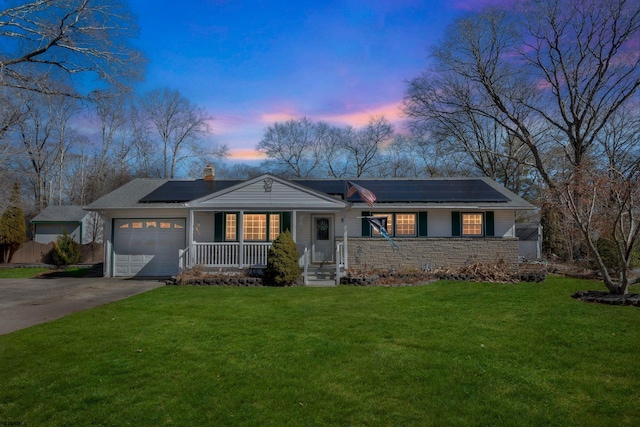 ranch-style house with a garage, a porch, concrete driveway, and a front yard