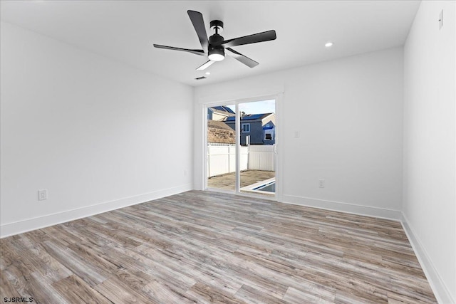 spare room with recessed lighting, light wood-style flooring, baseboards, and ceiling fan