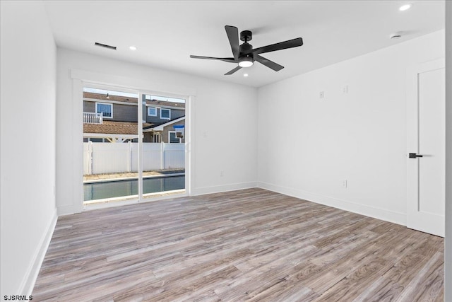 unfurnished room with recessed lighting, wood finished floors, baseboards, and ceiling fan