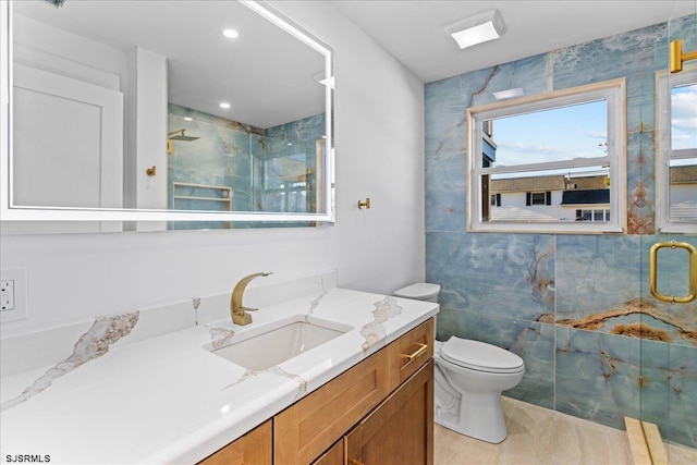 bathroom featuring vanity, a shower stall, toilet, and recessed lighting