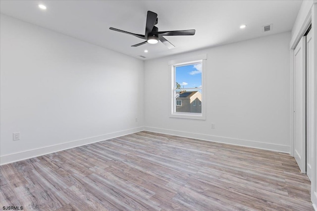 unfurnished bedroom featuring baseboards, light wood finished floors, recessed lighting, ceiling fan, and a closet