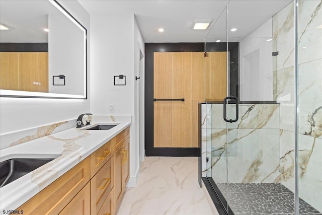 full bathroom featuring marble finish floor, a sink, recessed lighting, a marble finish shower, and double vanity