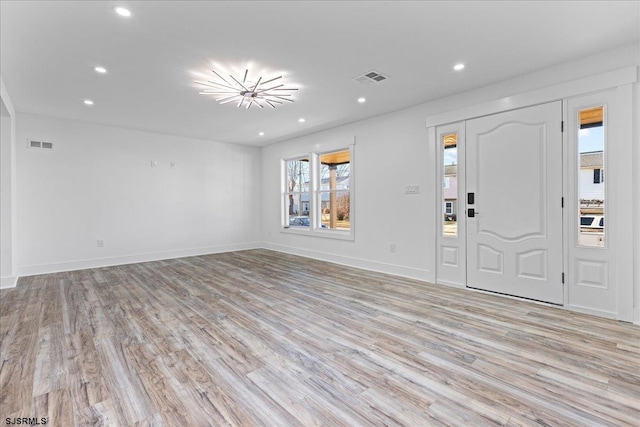 foyer with light wood-style flooring, recessed lighting, visible vents, and baseboards