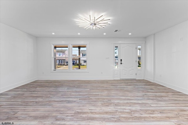 interior space featuring recessed lighting, light wood-style floors, visible vents, and baseboards