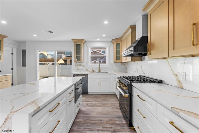 kitchen with backsplash, wall chimney range hood, dishwashing machine, high end stainless steel range oven, and a sink