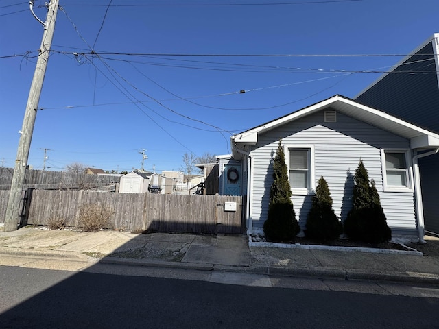 view of side of home with a fenced front yard