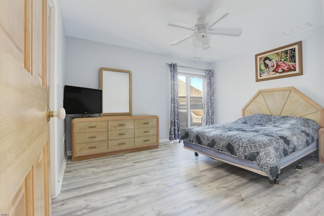 bedroom featuring light wood-type flooring, baseboards, visible vents, and ceiling fan