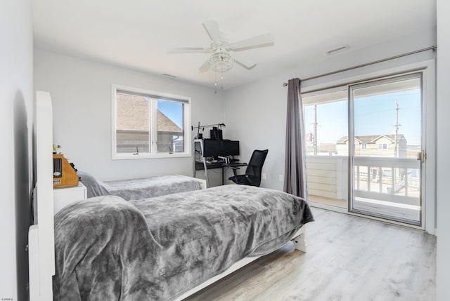 bedroom featuring visible vents, wood finished floors, access to exterior, and a ceiling fan