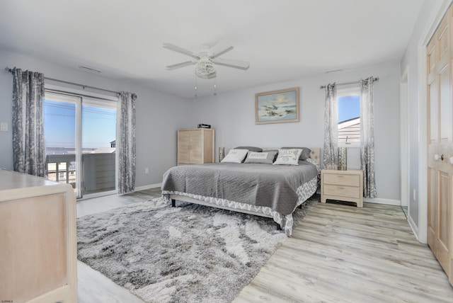 bedroom featuring a ceiling fan, visible vents, baseboards, light wood-style floors, and access to outside