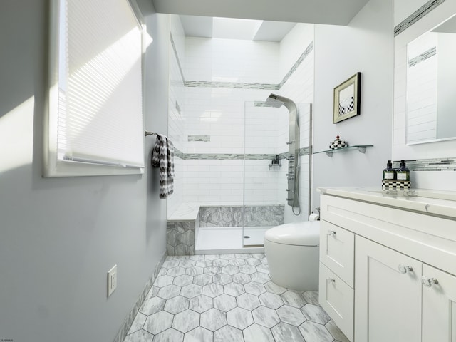 full bath featuring vanity, toilet, and a stall shower