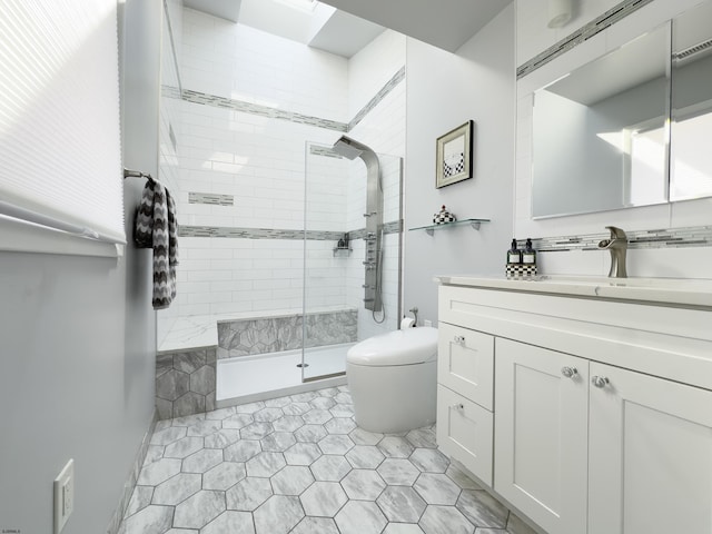 full bathroom featuring a shower stall, toilet, and vanity