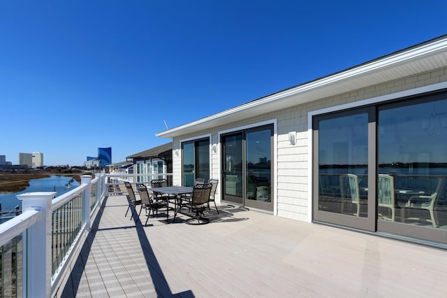 exterior space with outdoor dining area and a water view