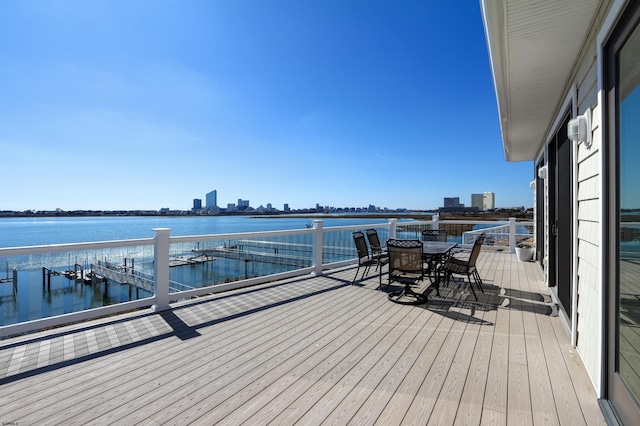 exterior space featuring outdoor dining area and a water view