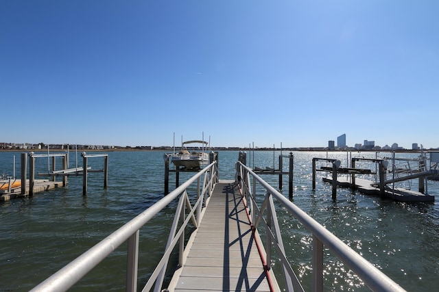 dock area with boat lift and a water view