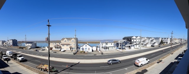 view of street with curbs, sidewalks, and a residential view