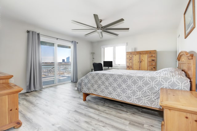 bedroom featuring a ceiling fan, access to outside, and wood finished floors