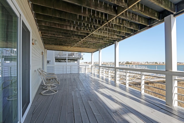 wooden terrace featuring a water view