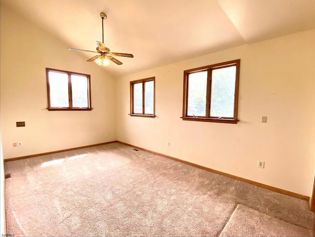 unfurnished room featuring light colored carpet, ceiling fan, baseboards, and vaulted ceiling