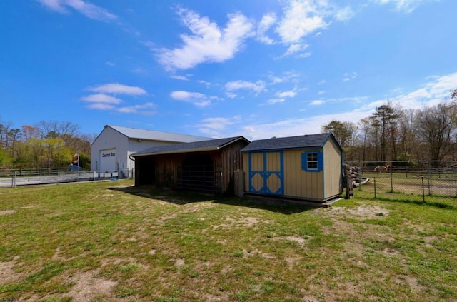 view of outdoor structure featuring an outbuilding and fence