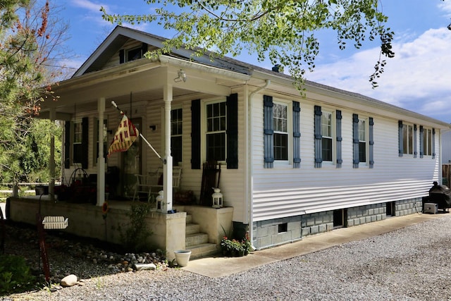 view of front of home with crawl space, covered porch, and driveway