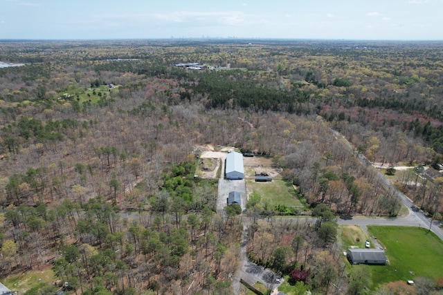 birds eye view of property with a view of trees