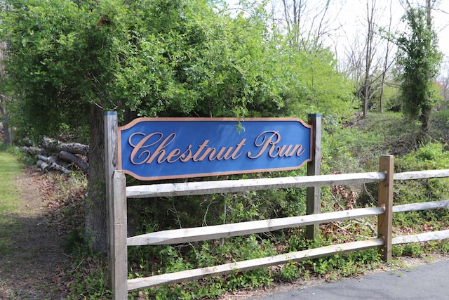 community / neighborhood sign with fence