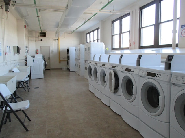 community laundry room featuring washing machine and dryer and visible vents