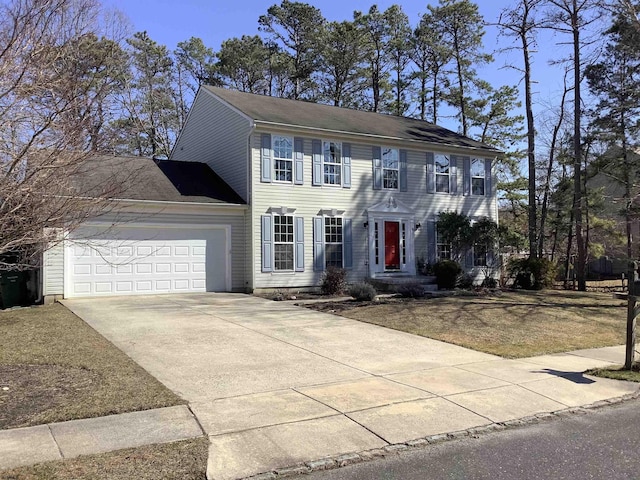 colonial home featuring driveway and an attached garage