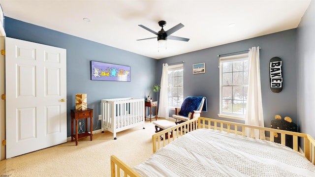 carpeted bedroom featuring baseboards and ceiling fan