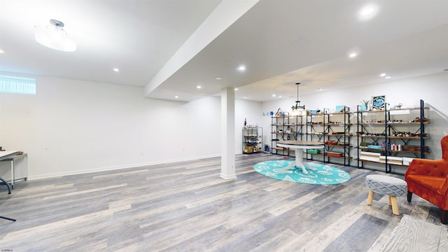 living area featuring recessed lighting, wood finished floors, and baseboards