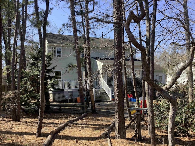 view of property exterior with stairway and covered porch