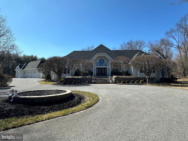 view of front of house featuring curved driveway and a garage