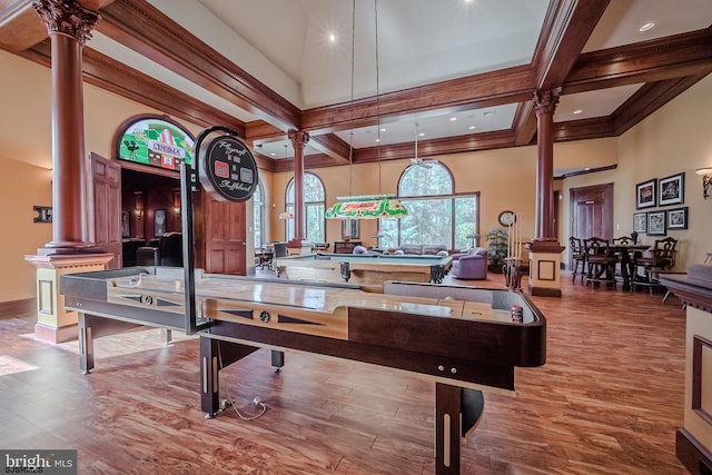 game room with beam ceiling, decorative columns, wood finished floors, and coffered ceiling