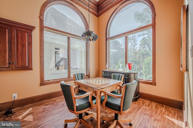 dining room featuring light wood-type flooring and baseboards